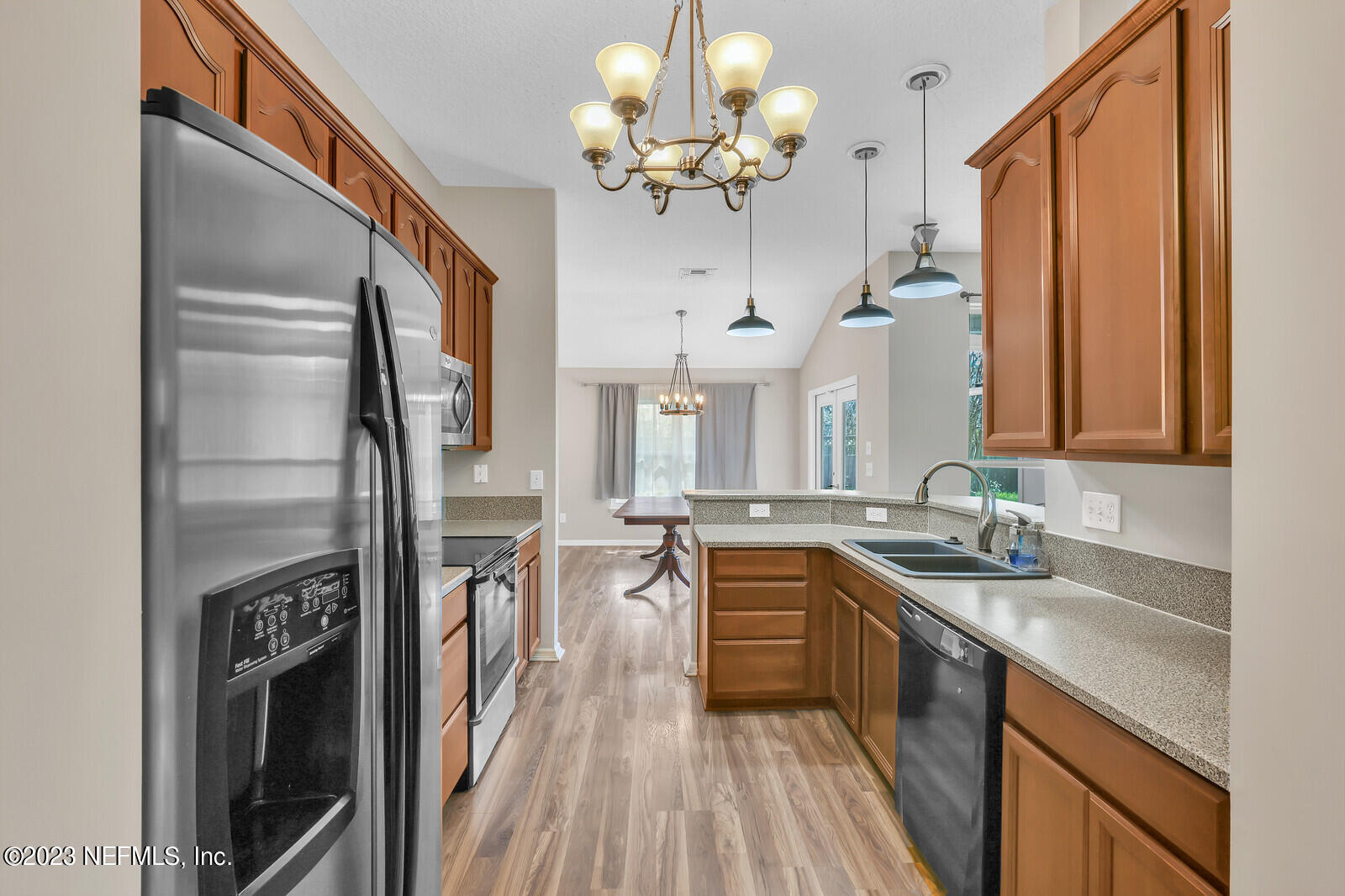 951 Silver Spring Court St. Augustine, FL 32092 - Photo 6 of 17 a kitchen with stainless steel appliances granite countertop a sink a stove and a refrigerator