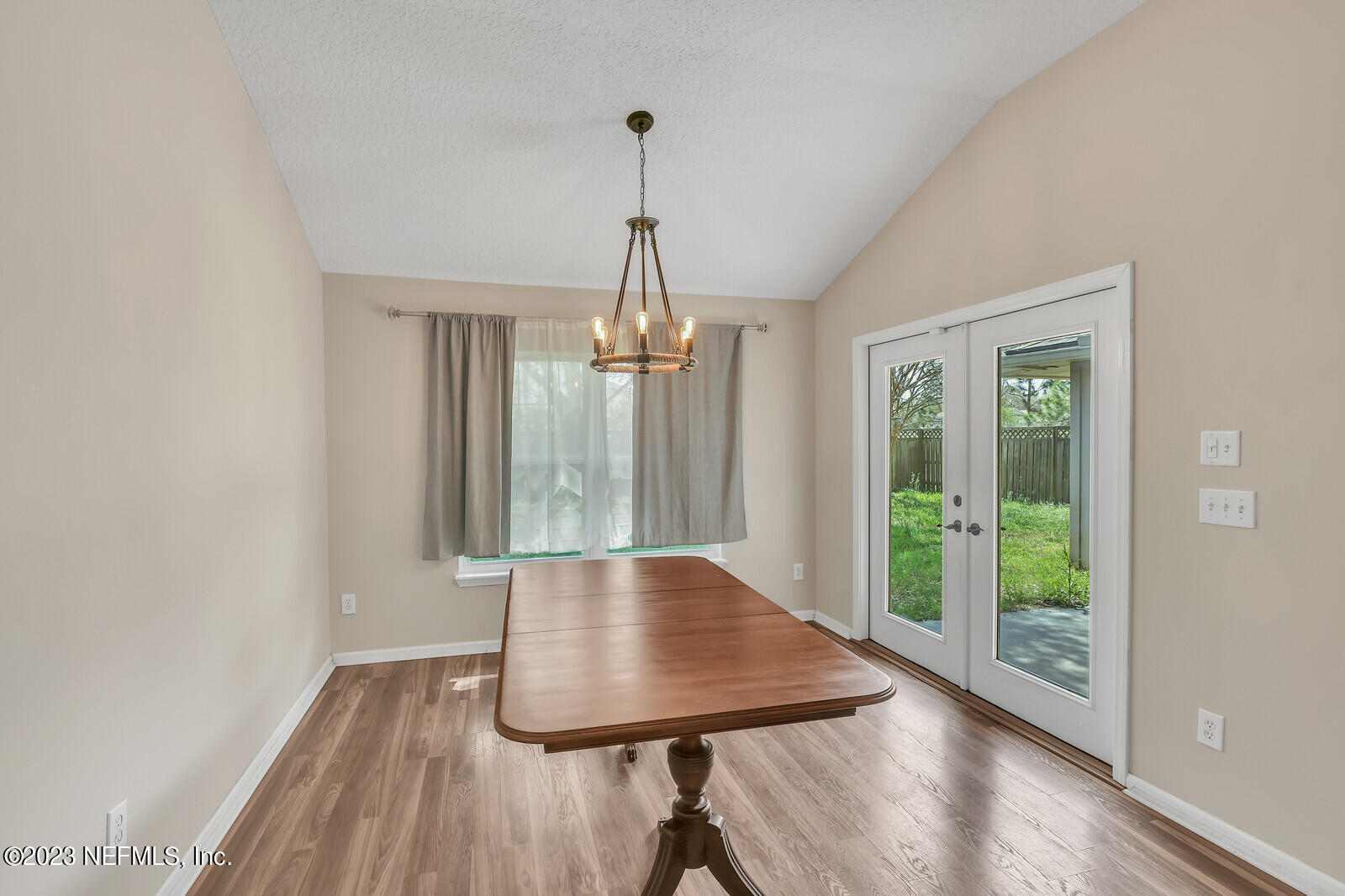 951 Silver Spring Court St. Augustine, FL 32092 - Photo 7 of 17 a view of a room with wooden floor chandelier and windows