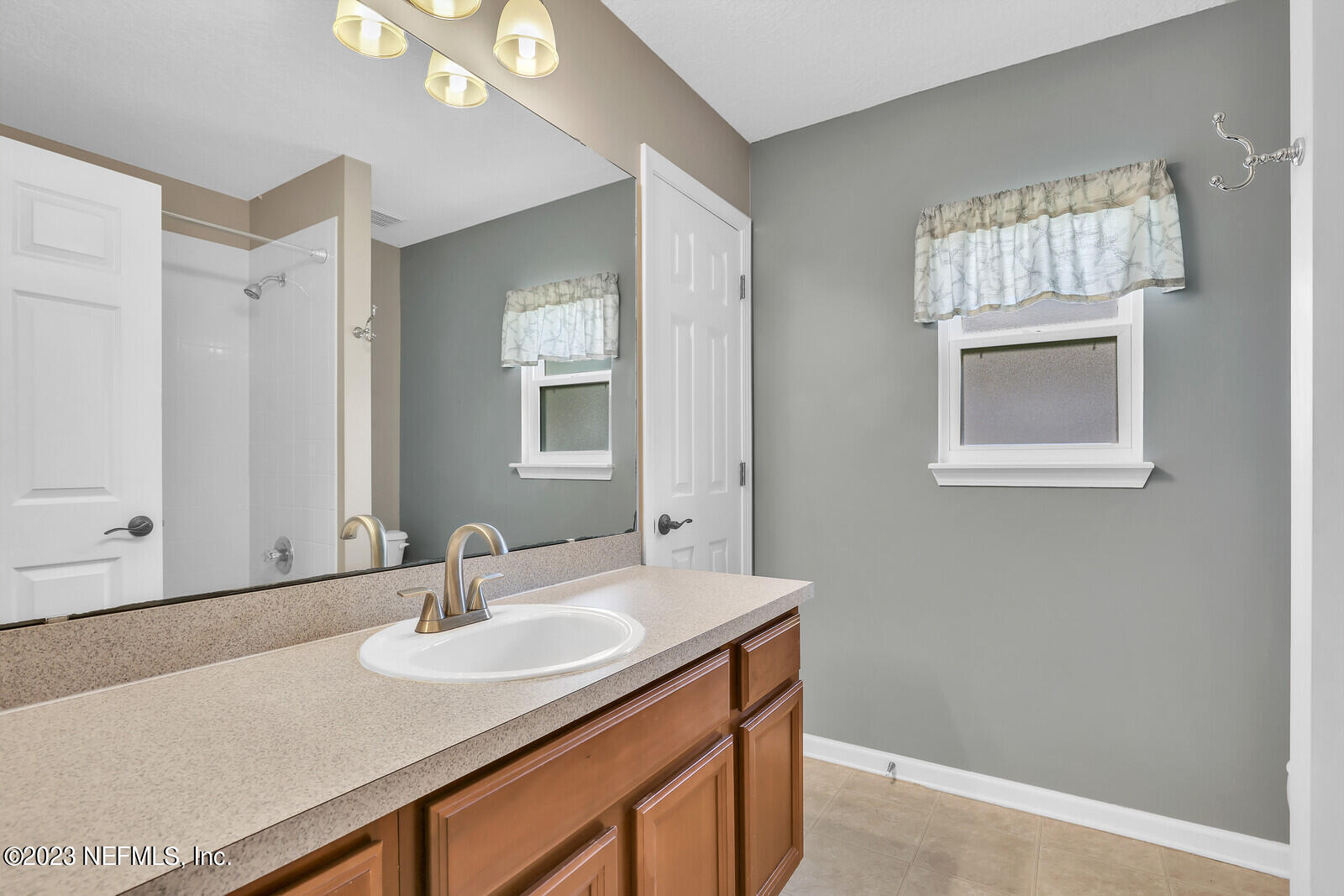 951 Silver Spring Court St. Augustine, FL 32092 - Photo 10 of 17 a bathroom with a sink and a mirror
