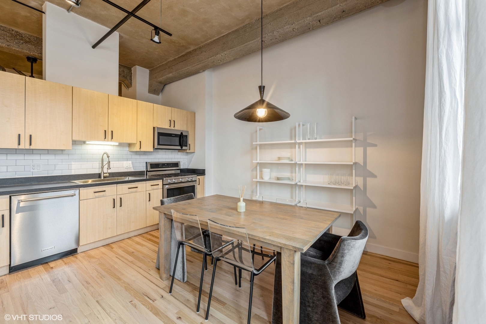 817 West Washington Boulevard, Unit 406 Chicago, IL 60607 - Photo 3 of 12 a kitchen with a table chairs stove and microwave