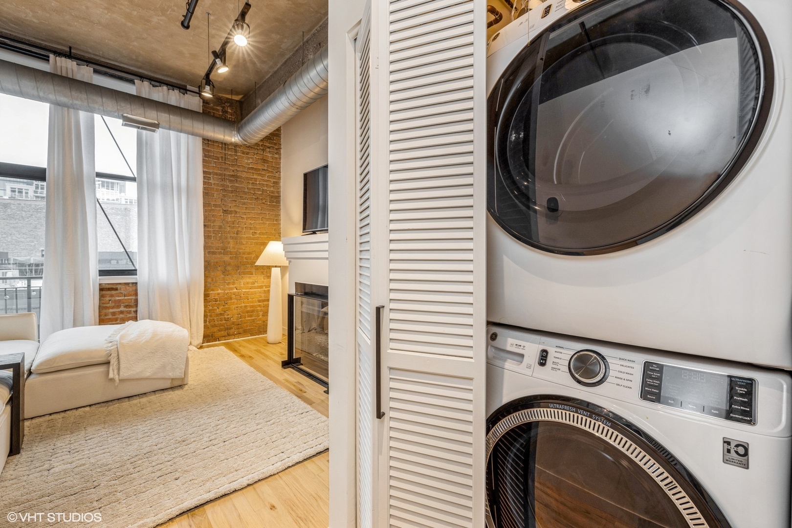817 West Washington Boulevard, Unit 406 Chicago, IL 60607 - Photo 7 of 12 a view of a bedroom with washer and dryer