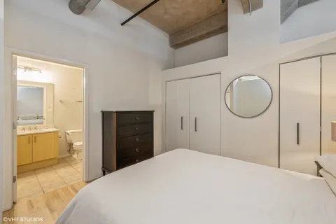 a bedroom with a bed and a mirror
