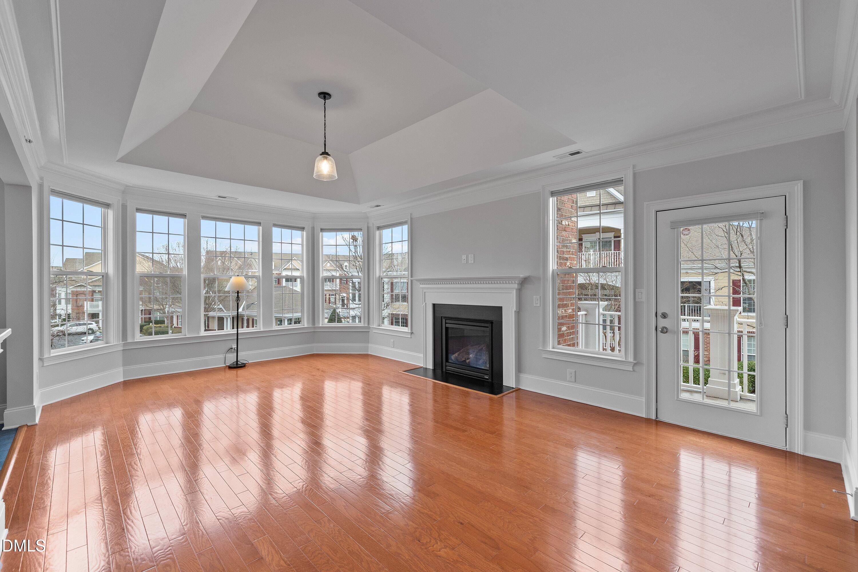 9211 Calabria Drive, Unit 205 Raleigh, NC 27617 - Photo 10 of 55 a view of an empty room with wooden floor and a window