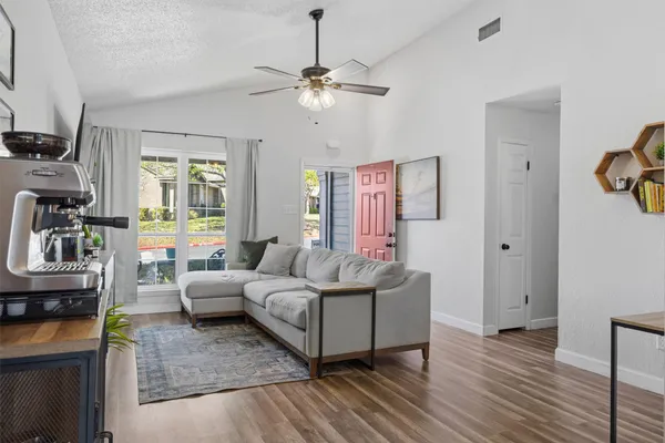 a living room with furniture and a chandelier