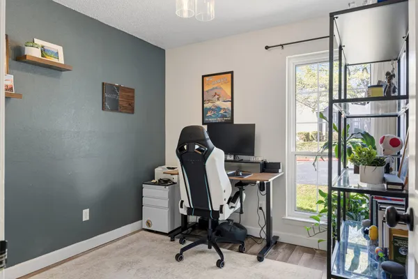 a view of workspace with wooden floor windows
