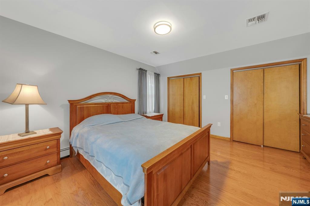 24 Cambridge Road Tenafly, NJ 07670 - Photo 20 of 31 a bedroom with a bed and a lamp