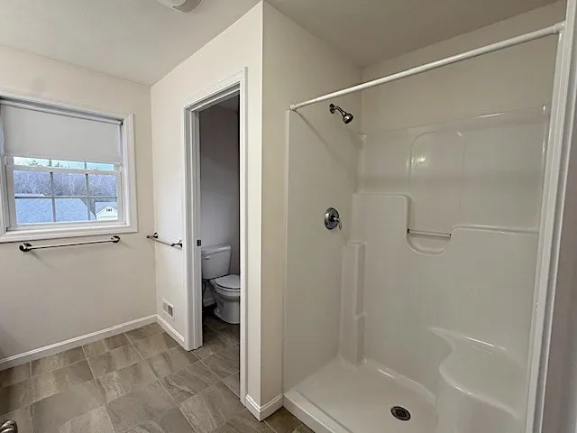 a bathroom that has a glass shower door