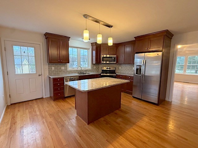 121 Robin Hill Road, Unit B Groton, MA 01450 - Photo 5 of 18 a kitchen with stainless steel appliances granite countertop a refrigerator a sink dishwasher a oven with wooden cabinets and wooden floor