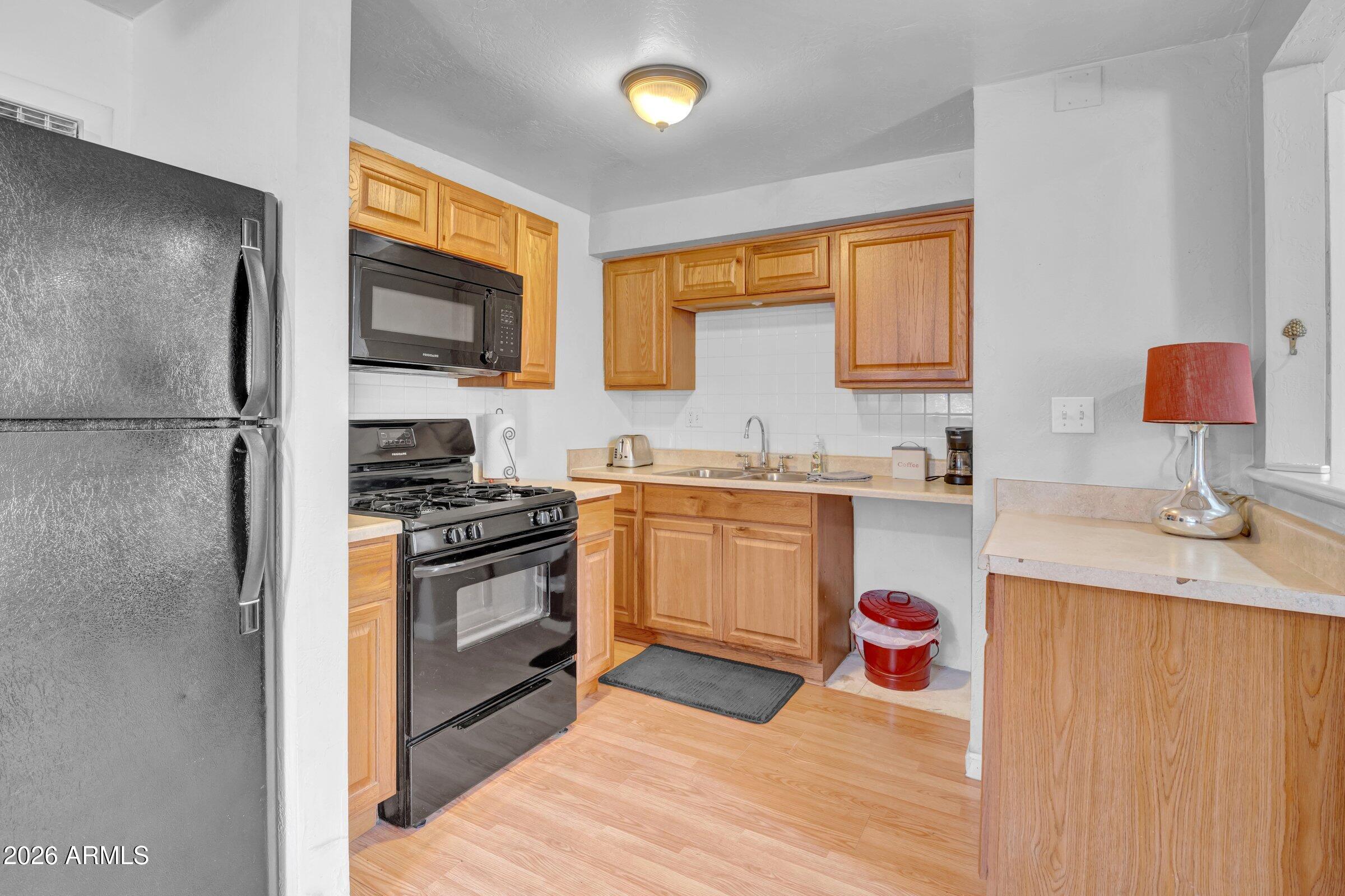 712 East Pierce Street Phoenix, AZ 85006 - Photo 23 of 39 a kitchen with a sink cabinets and stainless steel appliances