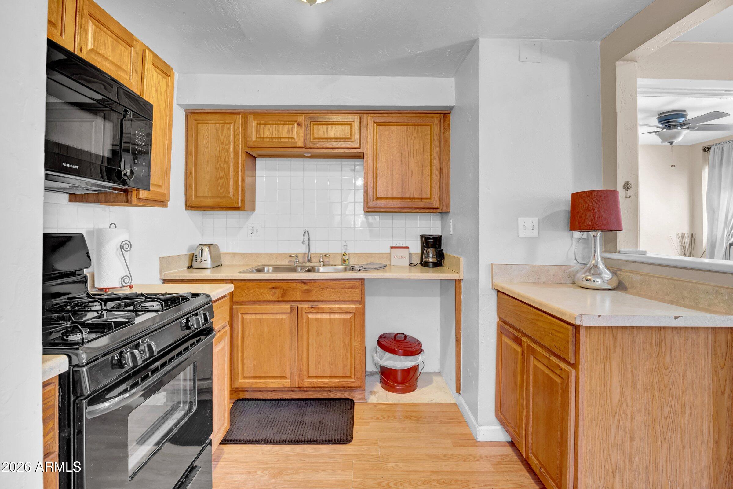 712 East Pierce Street Phoenix, AZ 85006 - Photo 24 of 39 a kitchen with stainless steel appliances granite countertop a sink stove and refrigerator