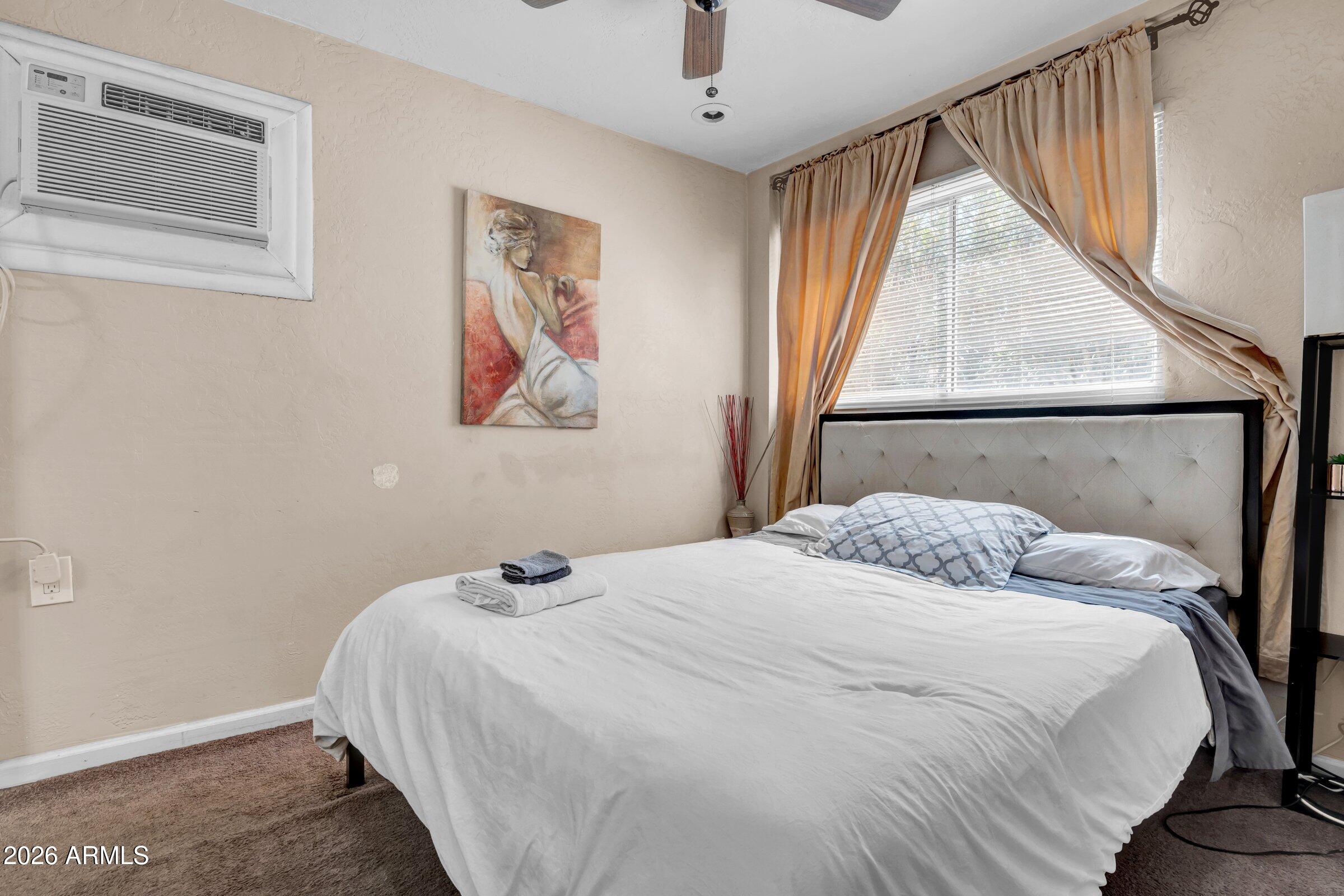 712 East Pierce Street Phoenix, AZ 85006 - Photo 26 of 39 a bedroom with a bed and a window