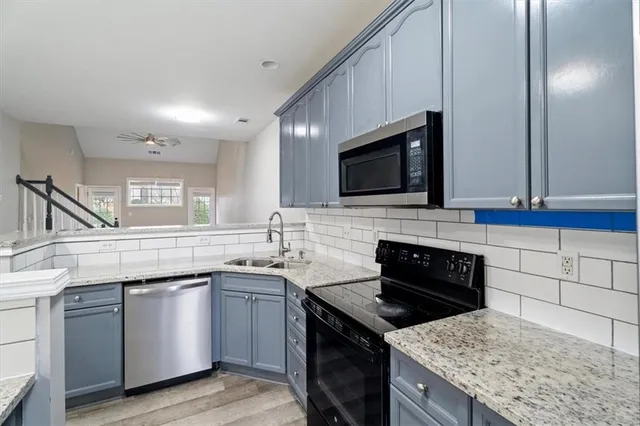 a kitchen with a sink stove and microwave