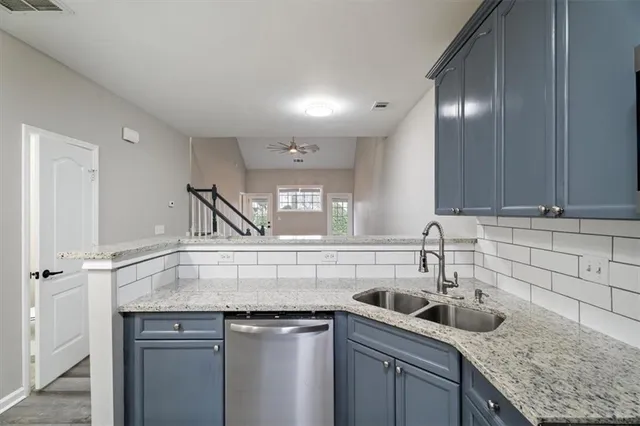 a kitchen with a sink a counter space and cabinets