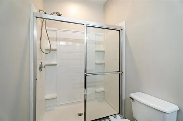 a bathroom with a glass shower door