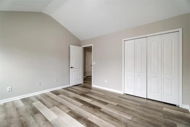a view of a room with wooden floor