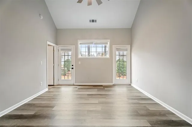 wooden floor in an empty room with a window