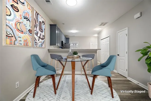 a view of a dining room with furniture and wooden floor