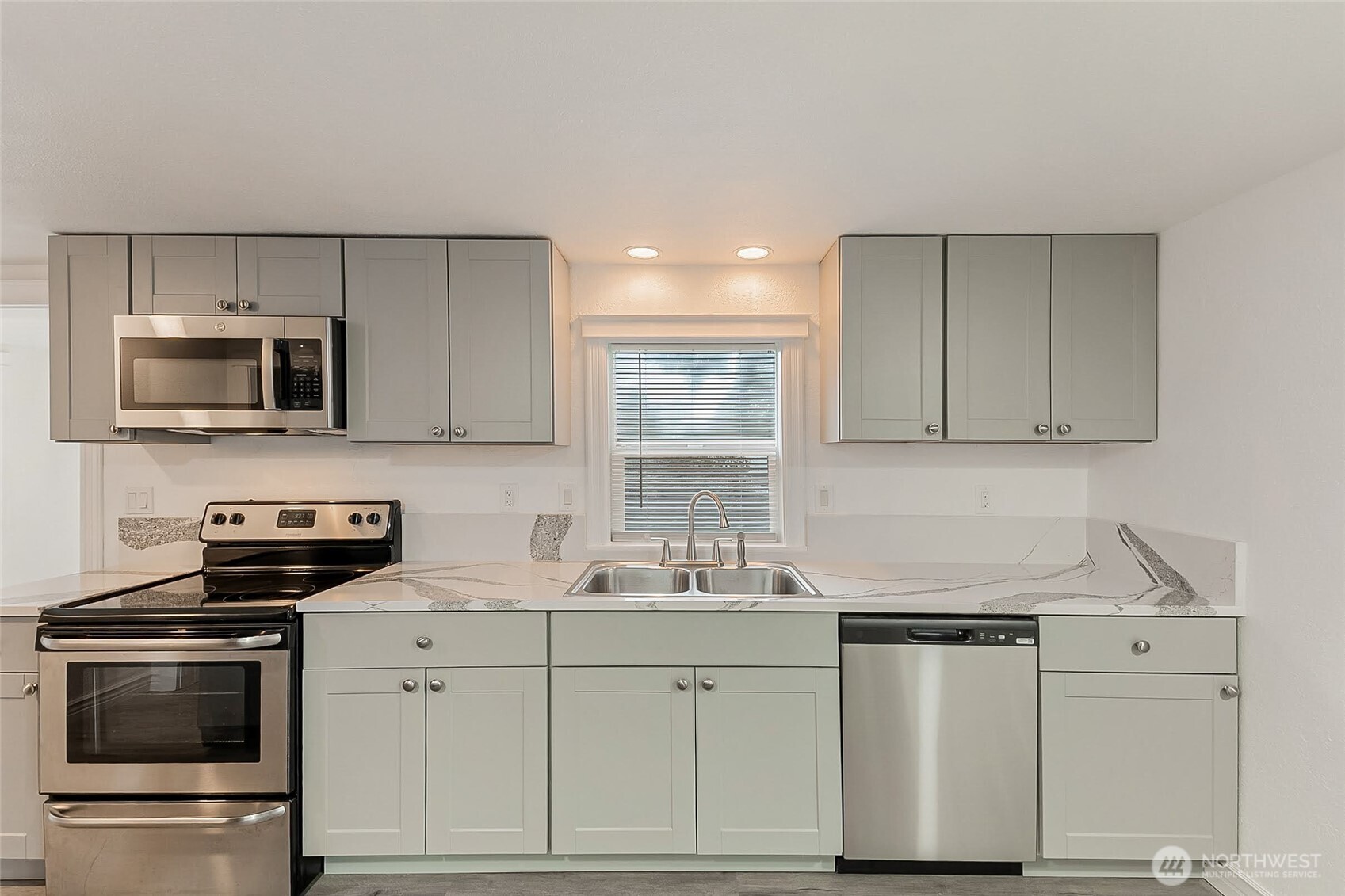 1607 Harrison Street Steilacoom, WA 98388 - Photo 11 of 37 a kitchen with stainless steel appliances granite countertop a sink stove and microwave