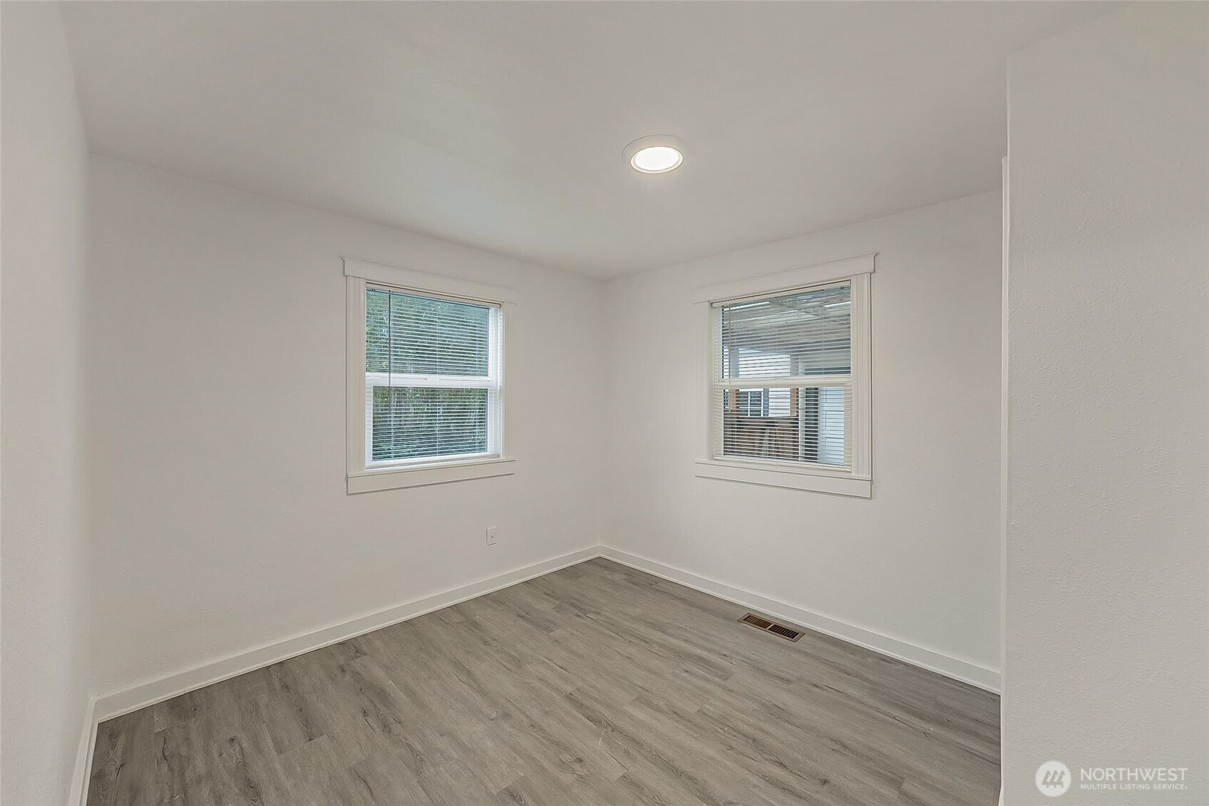 1607 Harrison Street Steilacoom, WA 98388 - Photo 17 of 37 a view of an empty room with wooden floor and a window