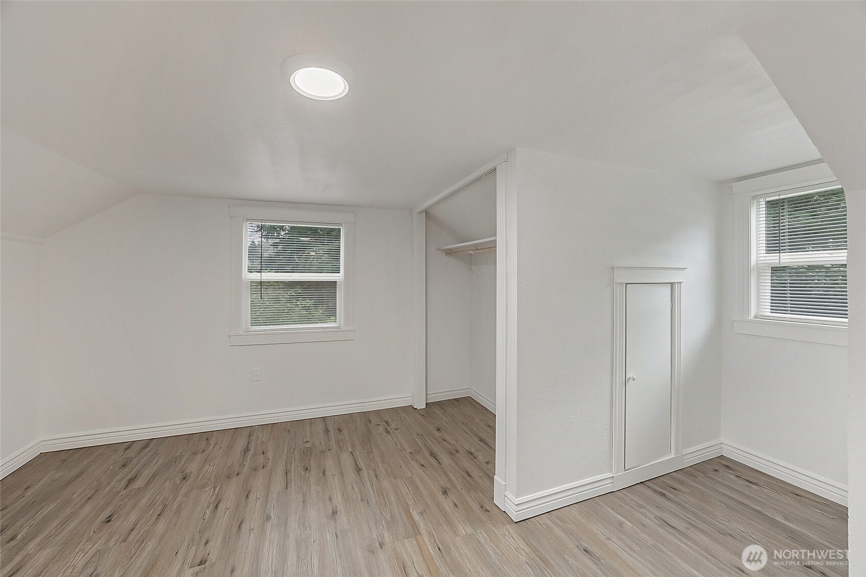 1607 Harrison Street Steilacoom, WA 98388 - Photo 24 of 37 an empty room with wooden floor and windows