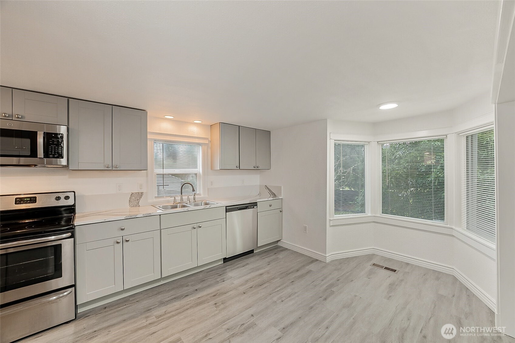 1607 Harrison Street Steilacoom, WA 98388 - Photo 8 of 37 a kitchen with a sink wooden floor and stainless steel appliances