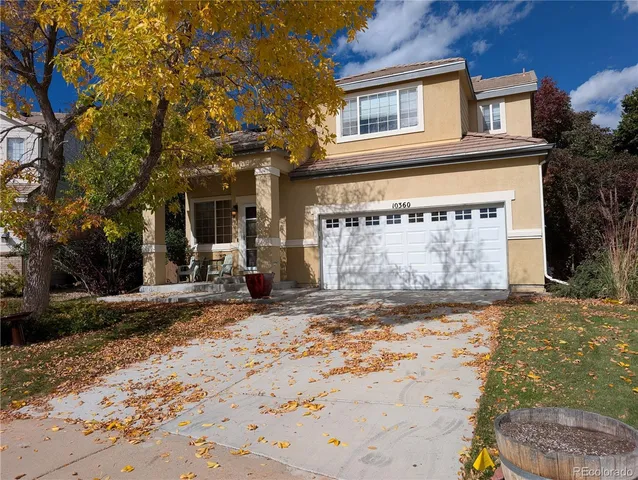 a view of a house with a yard and garage