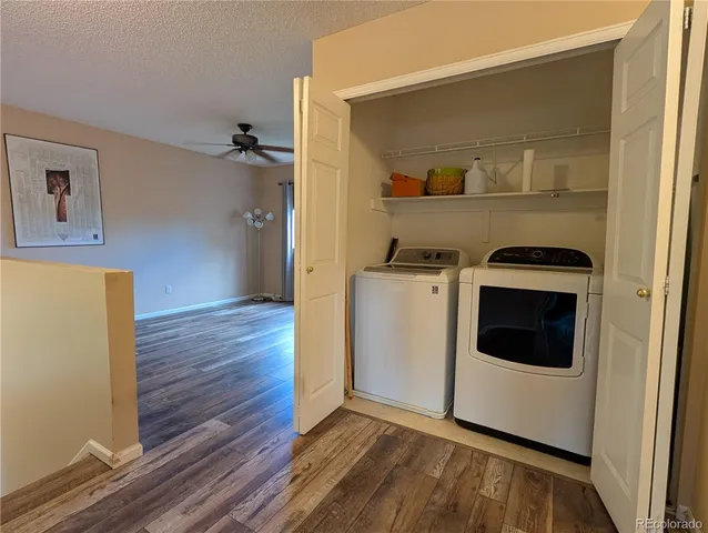 a view of a kitchen with wooden floor and a sink