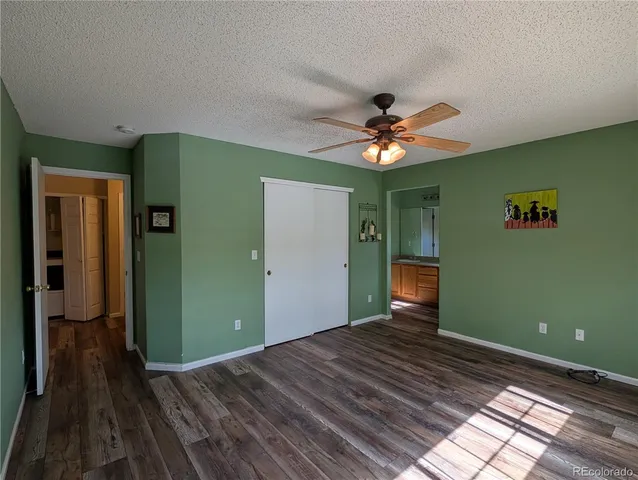 a bedroom with a bed and a chandelier fan
