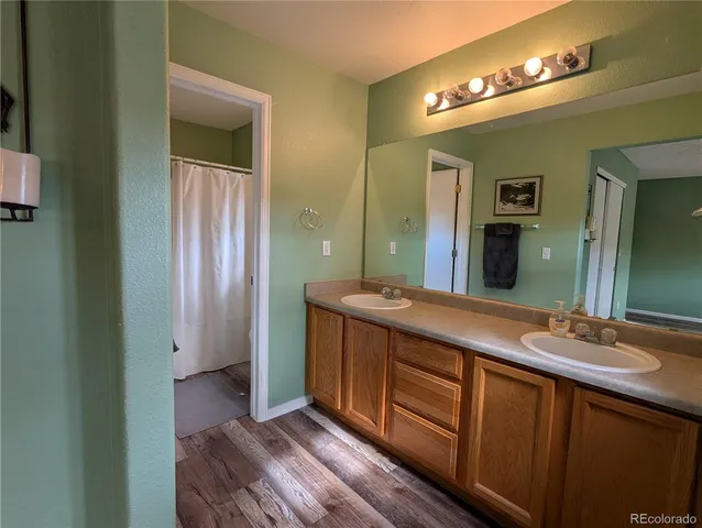 a bathroom with a double vanity sink and a mirror