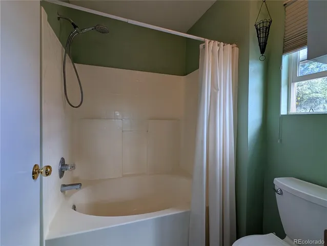 a bathroom with a bath tub with a shower