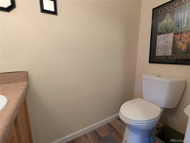 a white toilet sitting next to a white wall