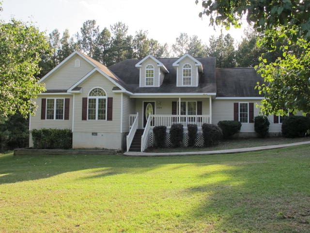 1644 Klopfer Road Juliette, GA 31046 - Photo 1 of 16 a front view of a house with a garden and yard