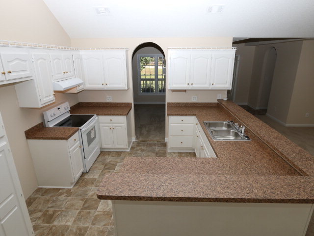 1644 Klopfer Road Juliette, GA 31046 - Photo 2 of 16 a kitchen with stainless steel appliances granite countertop a sink a stove and a refrigerator
