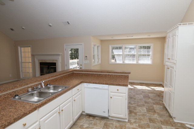 1644 Klopfer Road Juliette, GA 31046 - Photo 11 of 16 a kitchen with a sink stove and cabinets