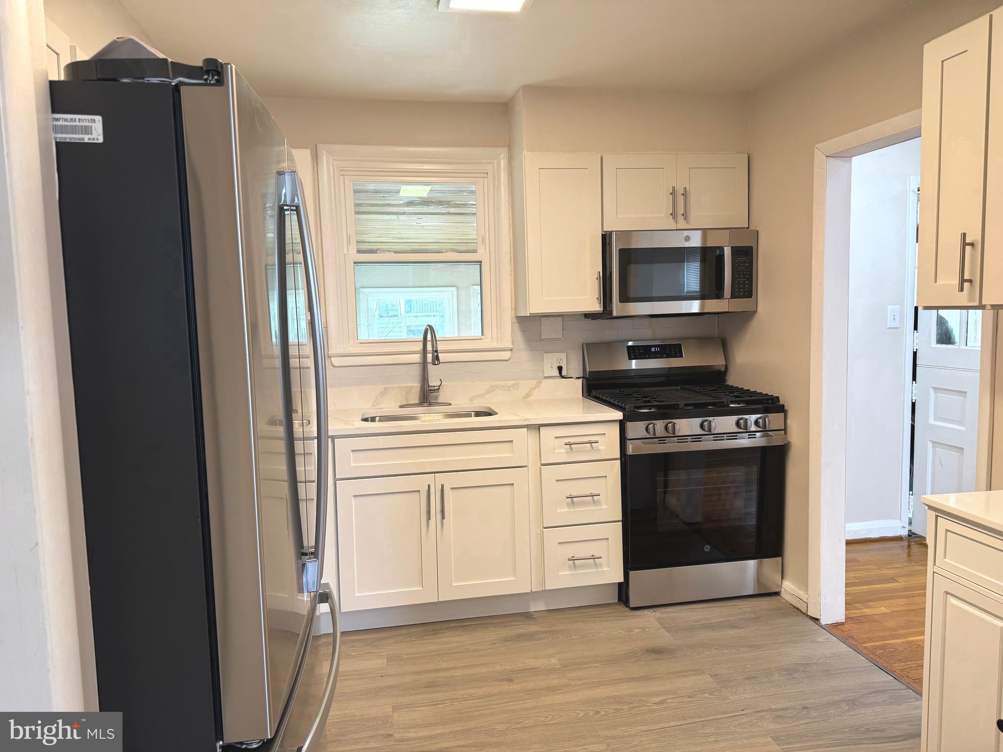 609 Wallerson Road Baltimore, MD 21228 - Photo 7 of 15 a kitchen with stainless steel appliances granite countertop a refrigerator stove and sink