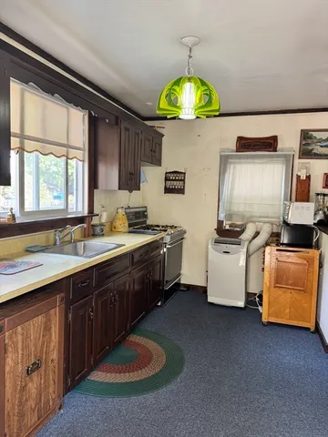 a kitchen with a sink cabinets and window