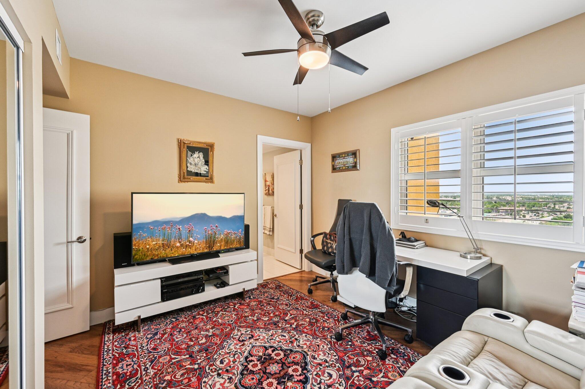 2640 Lake Shore Drive, Unit 1510 Riviera Beach, FL 33404 - Photo 21 of 52 a living room with furniture and a flat screen tv
