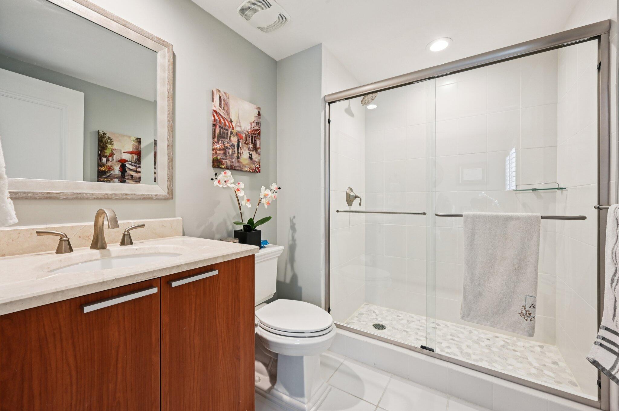 2640 Lake Shore Drive, Unit 1510 Riviera Beach, FL 33404 - Photo 23 of 52 a bathroom with a sink a toilet and shower