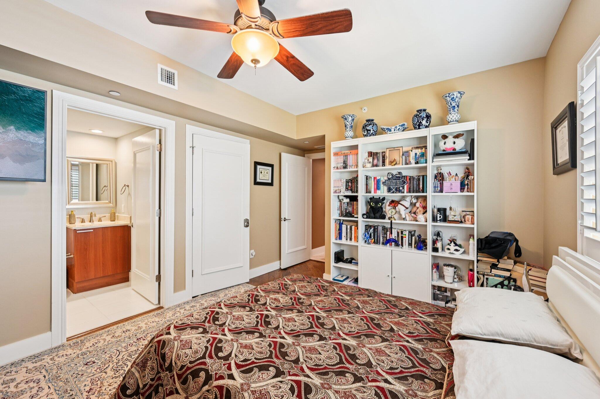 2640 Lake Shore Drive, Unit 1510 Riviera Beach, FL 33404 - Photo 24 of 52 a bedroom with a bed and a book shelf