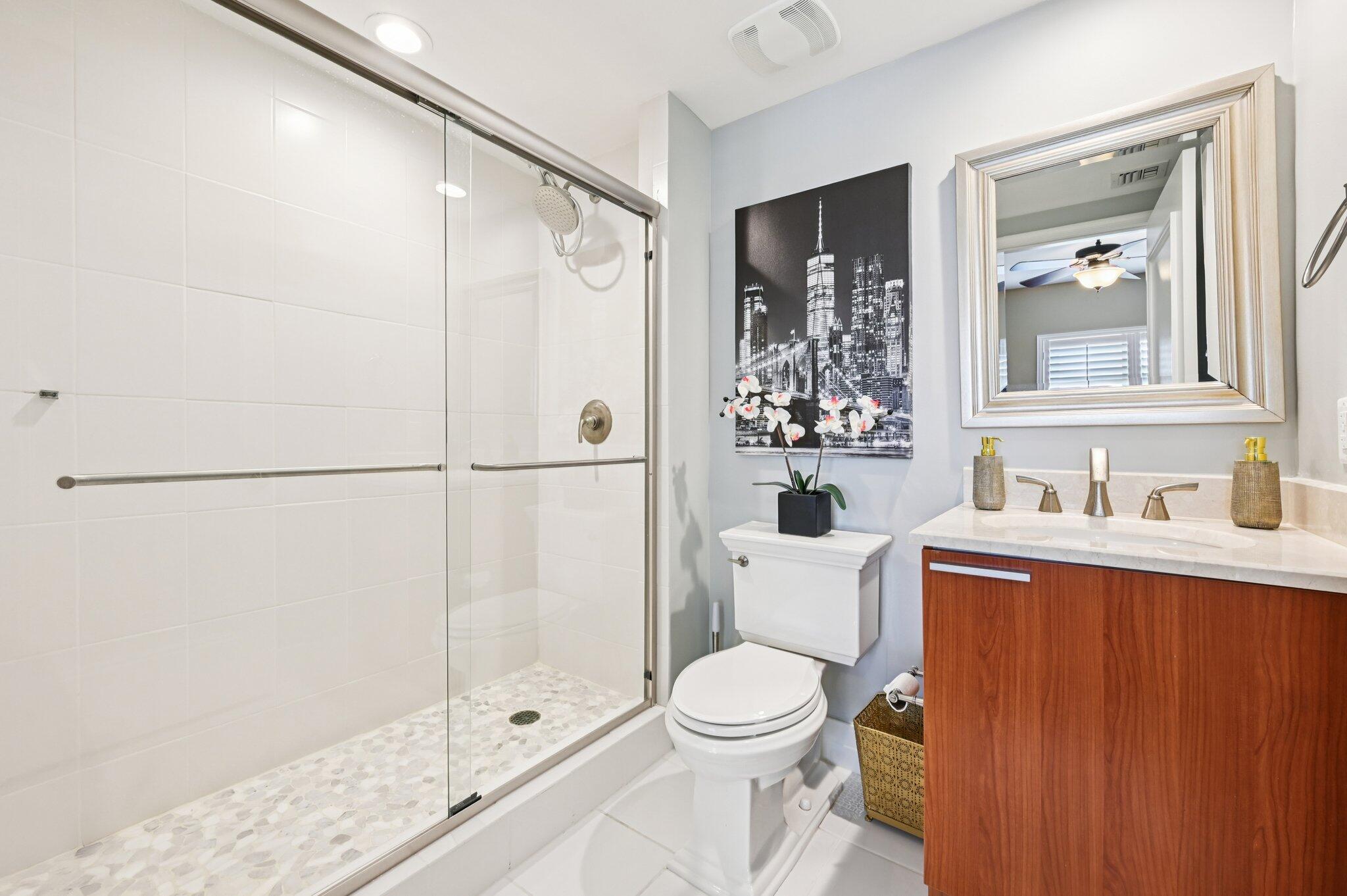 2640 Lake Shore Drive, Unit 1510 Riviera Beach, FL 33404 - Photo 26 of 52 a bathroom with a sink toilet and shower