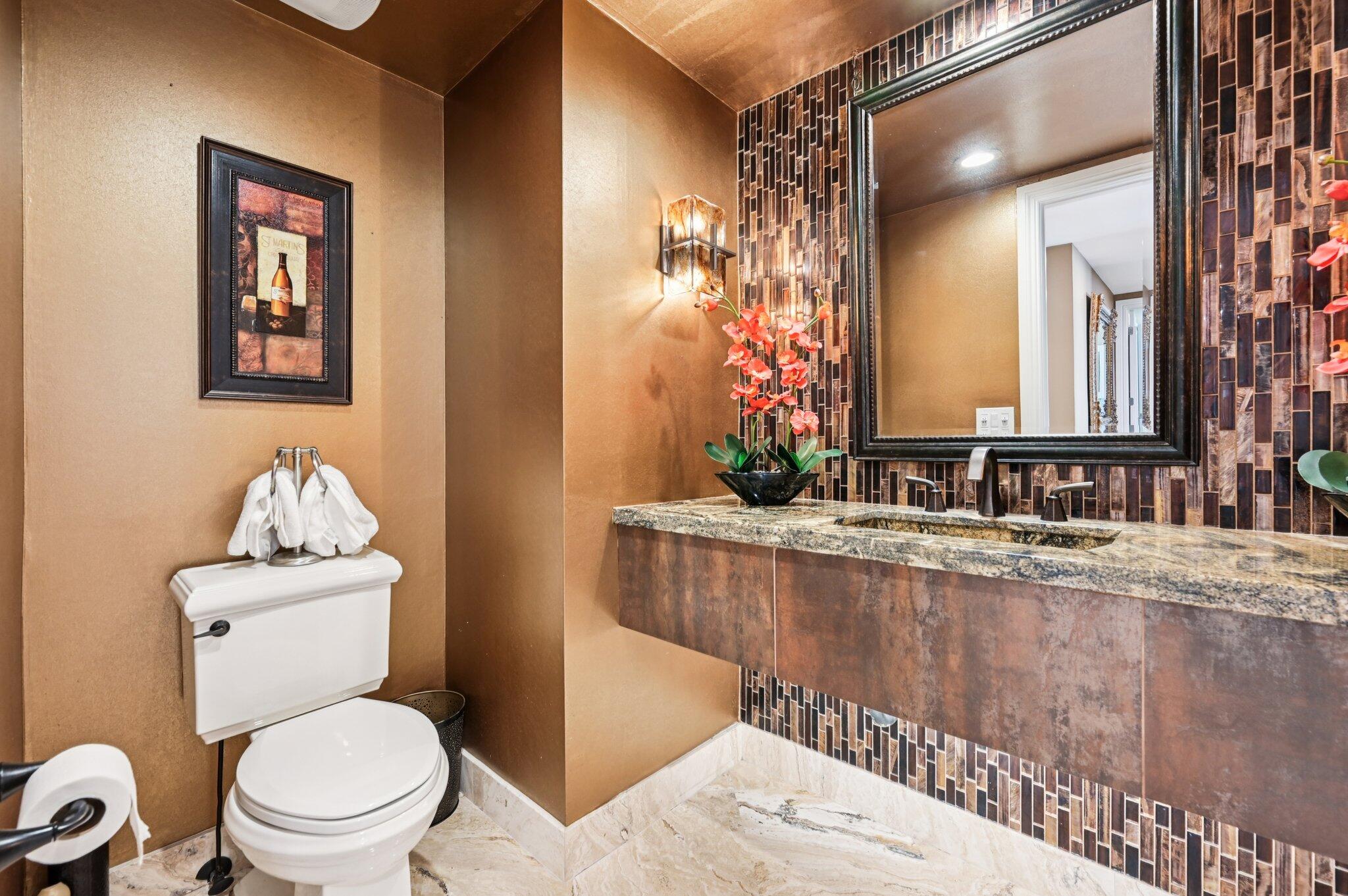 2640 Lake Shore Drive, Unit 1510 Riviera Beach, FL 33404 - Photo 27 of 52 a bathroom with a granite countertop sink mirror vanity and toilet