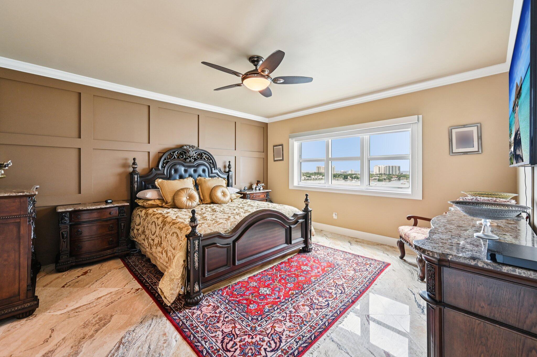 2640 Lake Shore Drive, Unit 1510 Riviera Beach, FL 33404 - Photo 29 of 52 a bedroom with a bed and wooden floor