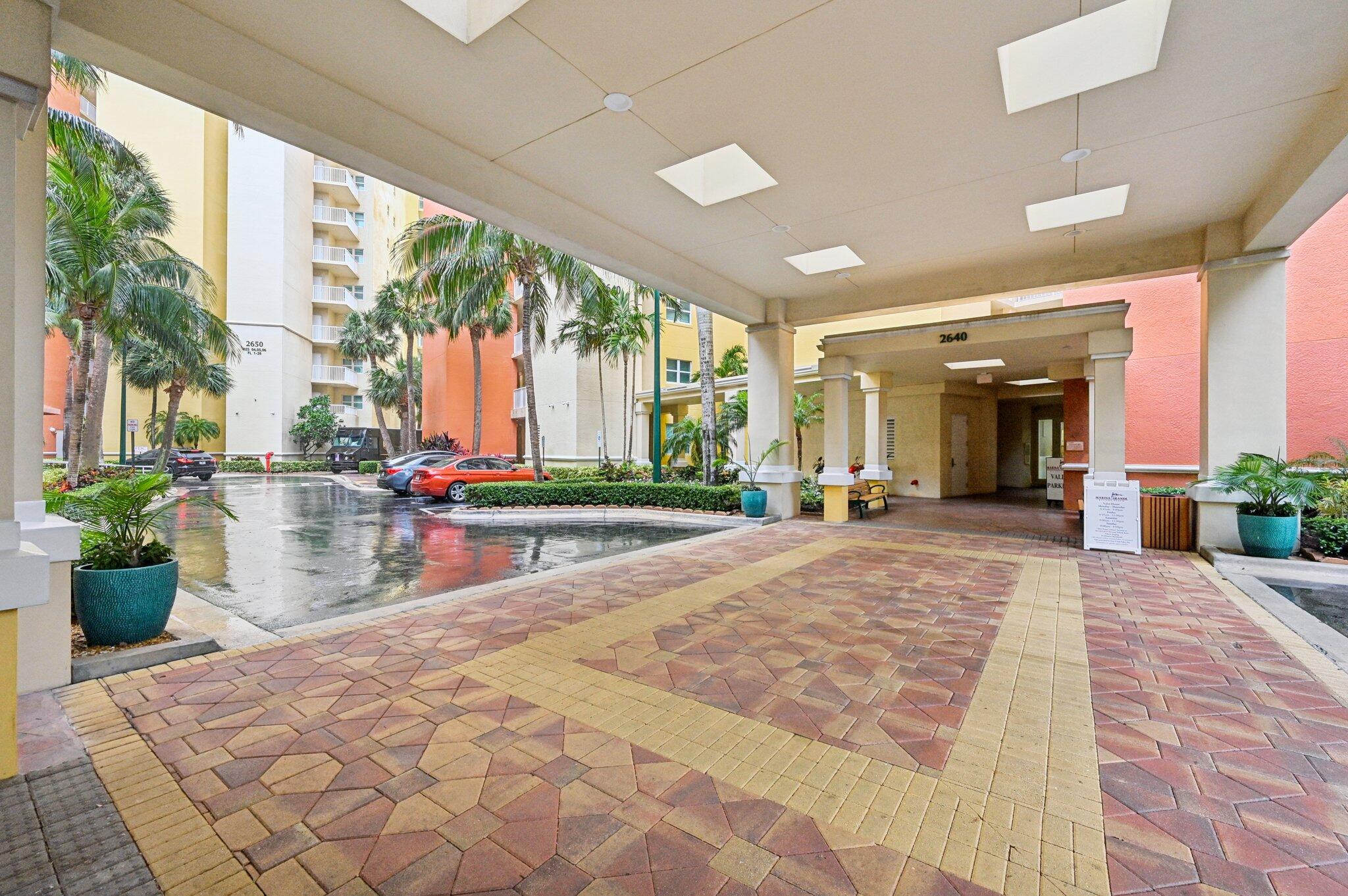 2640 Lake Shore Drive, Unit 1510 Riviera Beach, FL 33404 - Photo 4 of 52 a view of a lobby with chair and tables