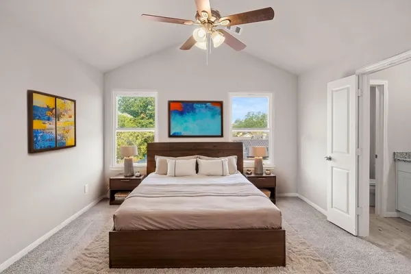 a bedroom with a bed and a painting on the wall