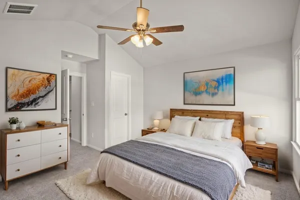 a bedroom with a bed and a cabinet