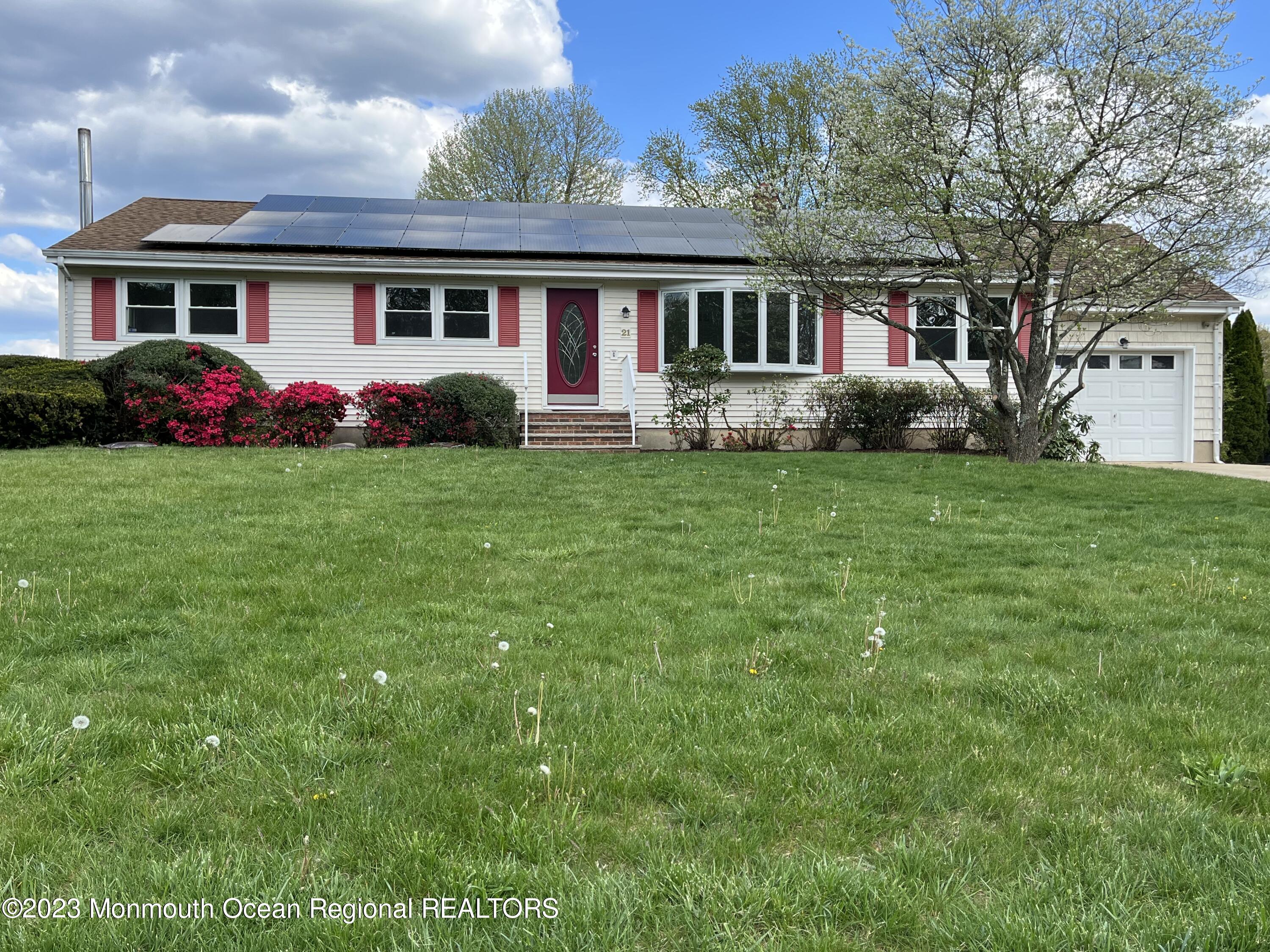 21 Glenmore Road Freehold, NJ 07728 - Photo 2 of 14 a front view of a house with garden