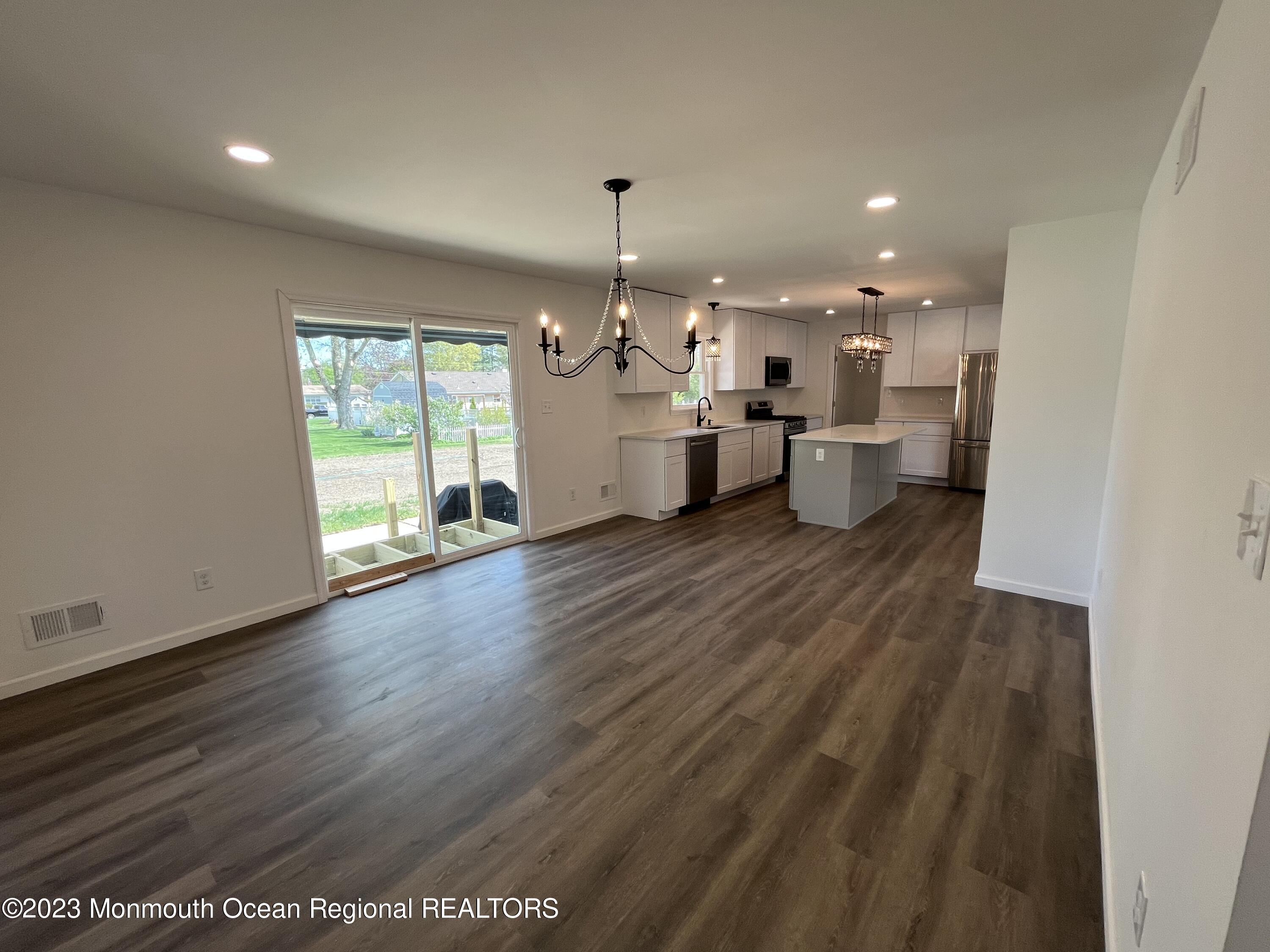 21 Glenmore Road Freehold, NJ 07728 - Photo 5 of 14 a open kitchen with white cabinets and wooden floor