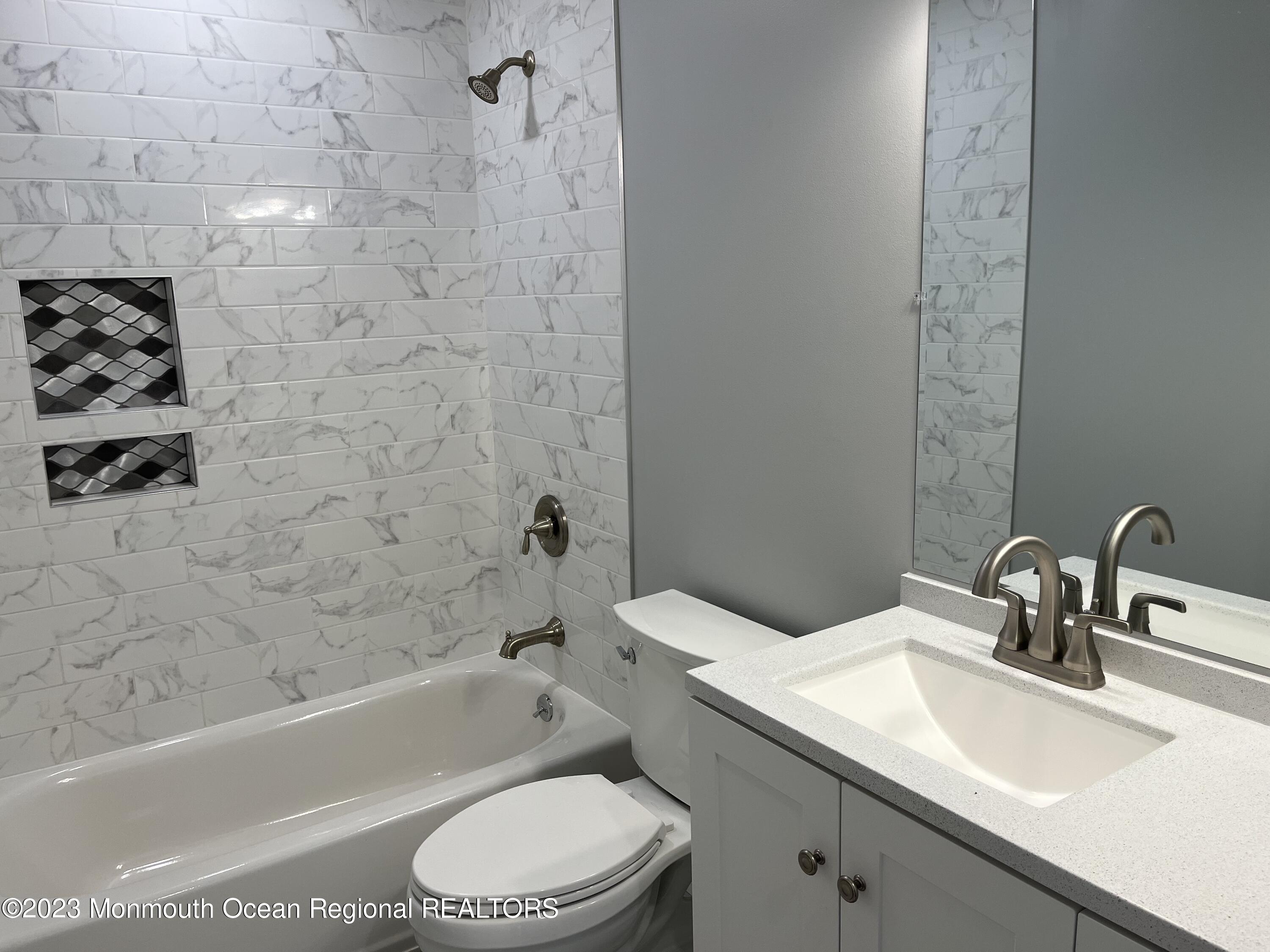 21 Glenmore Road Freehold, NJ 07728 - Photo 6 of 14 a bathroom with a sink a toilet and bathtub