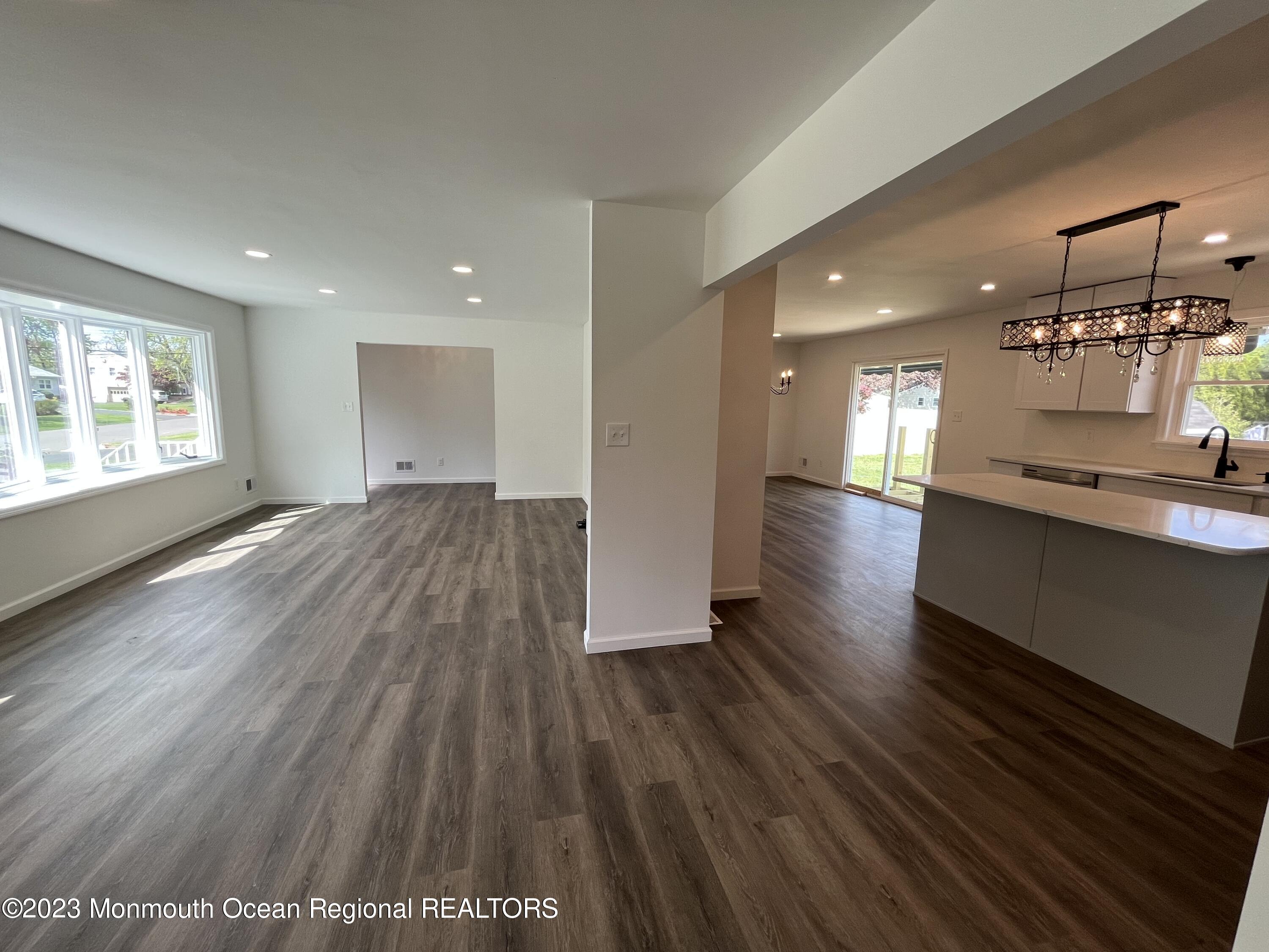 21 Glenmore Road Freehold, NJ 07728 - Photo 7 of 14 an empty room with wooden floor and windows