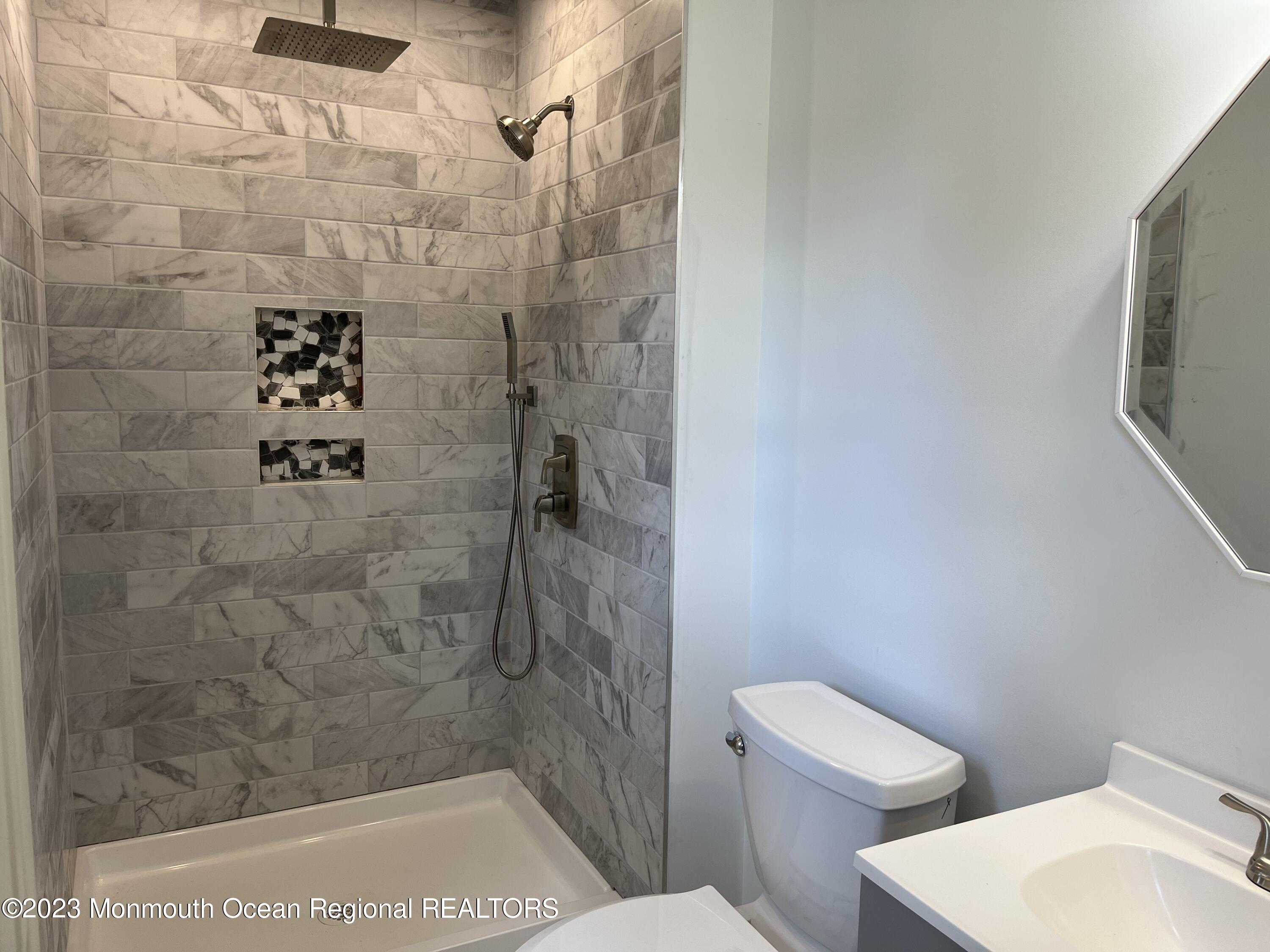 21 Glenmore Road Freehold, NJ 07728 - Photo 9 of 14 a bathroom with a shower and toilet